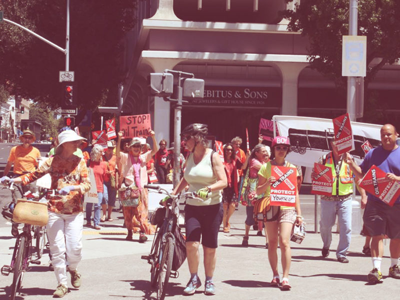 Activists march in Downtown Sacramento to protest Oil Trains. Photo attributed to 350 Sacramento.