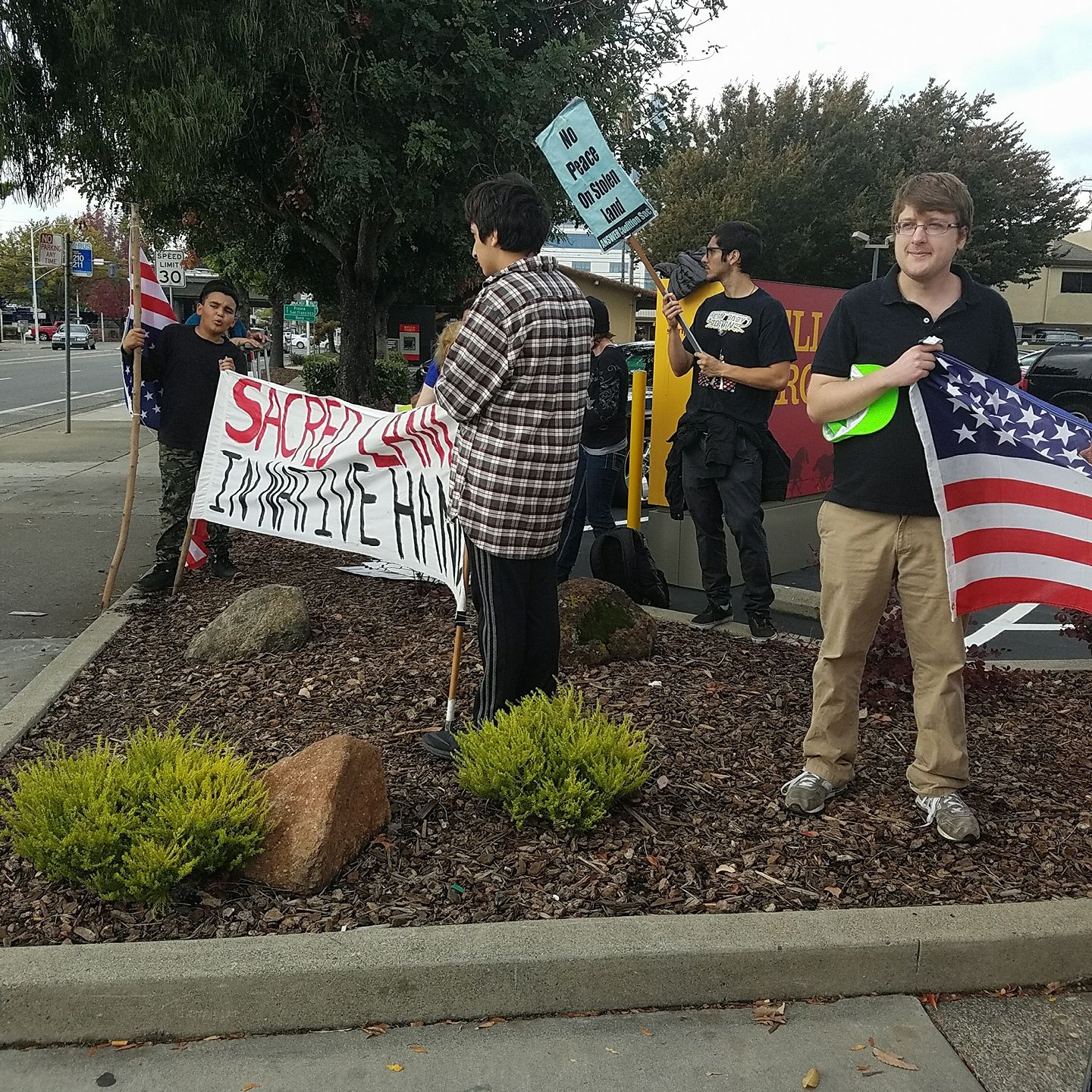 volunteers standing on a street corner protesting Keystone XL pipeline