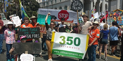 volunteers at the Fossil Free LA March holding signs