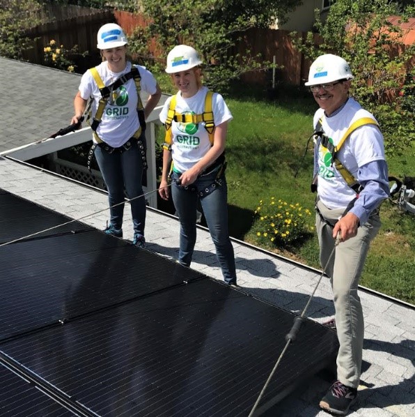 Volunteers on a roof with solar panels
