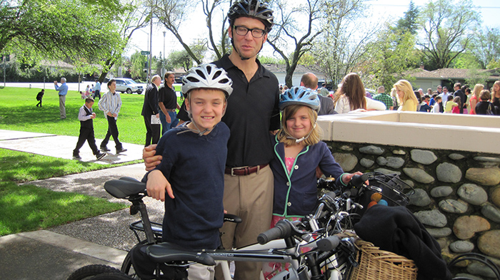a father and two kids with bikes